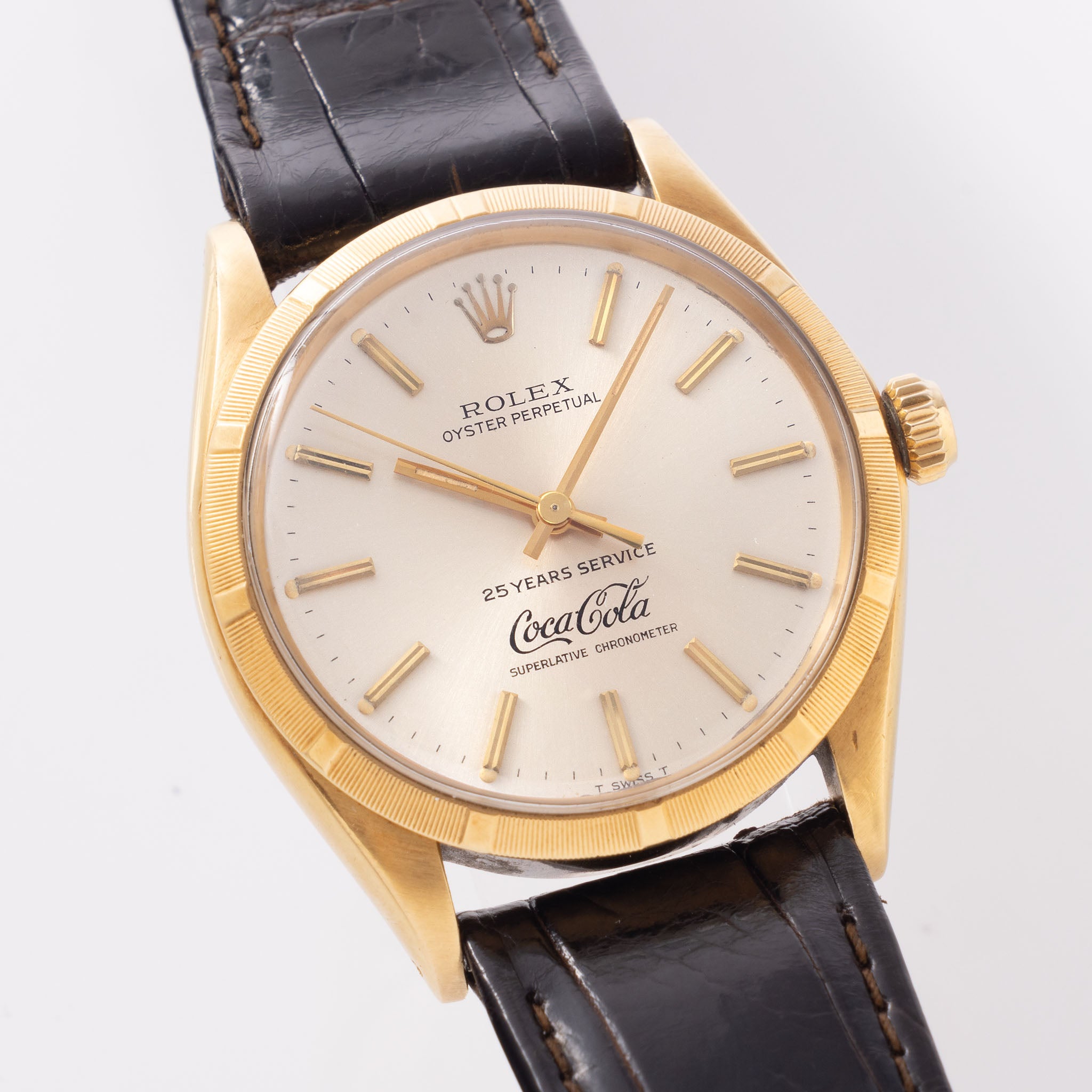 Rolex Oyster -Perpetual silver "25 years Coca Cola service " logo dial in 18 k yellow gold with original double punched papers ref 1003