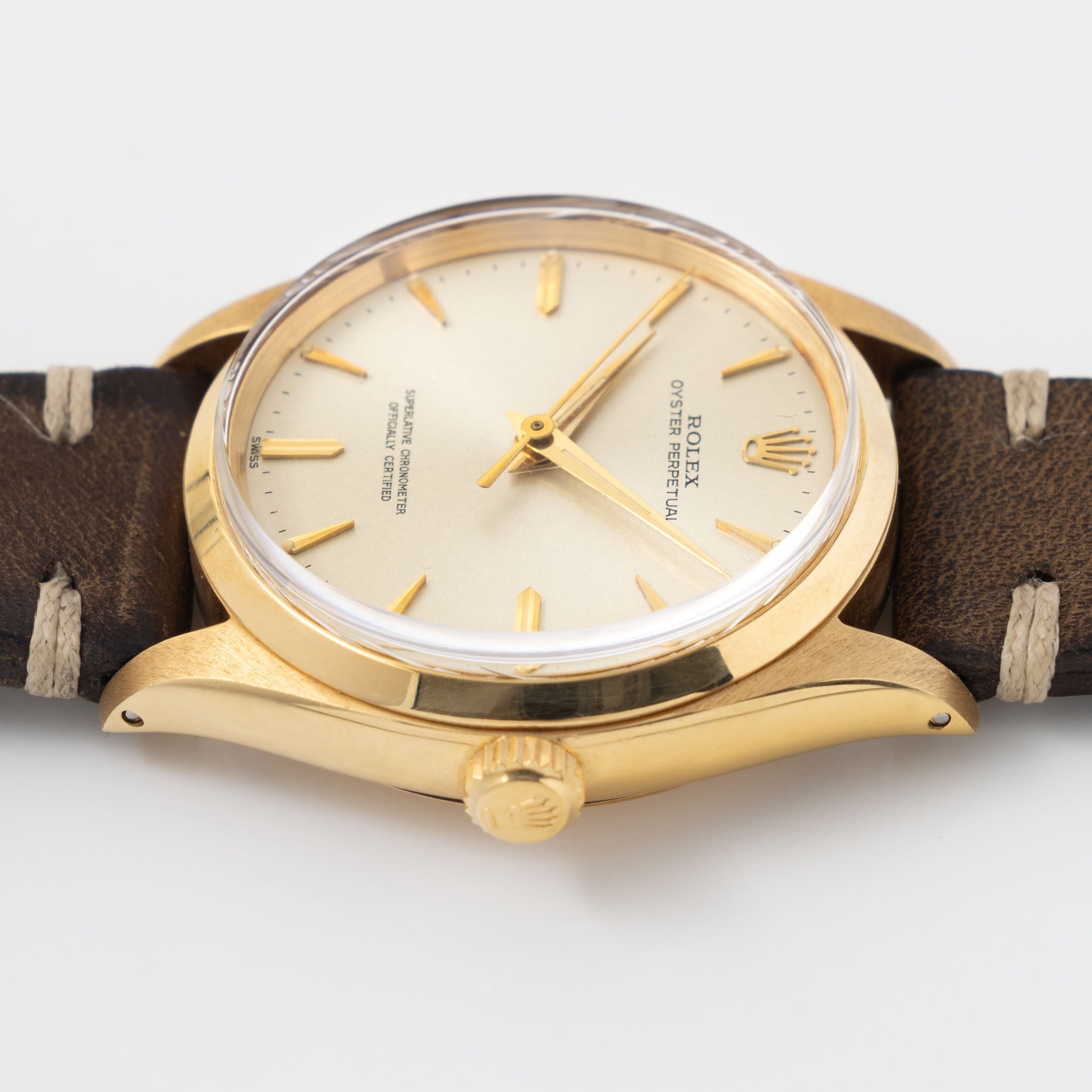 Rolex Oyster Perpetual 1002 Silver Soleil Swiss Only Dial in 18 k yellow gold Coca Cola